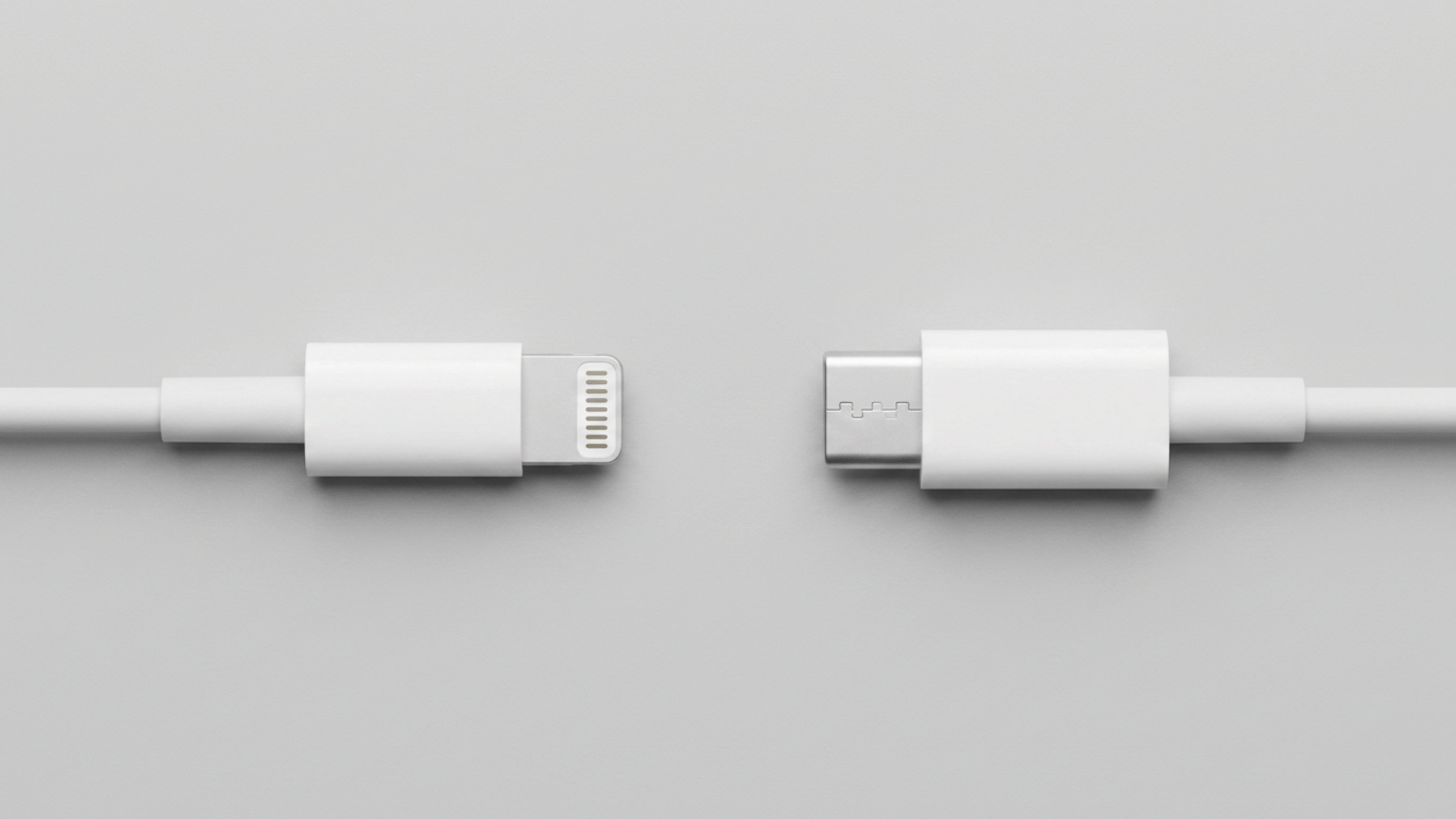 two charging connectors placed side by side on flat surface for comparison