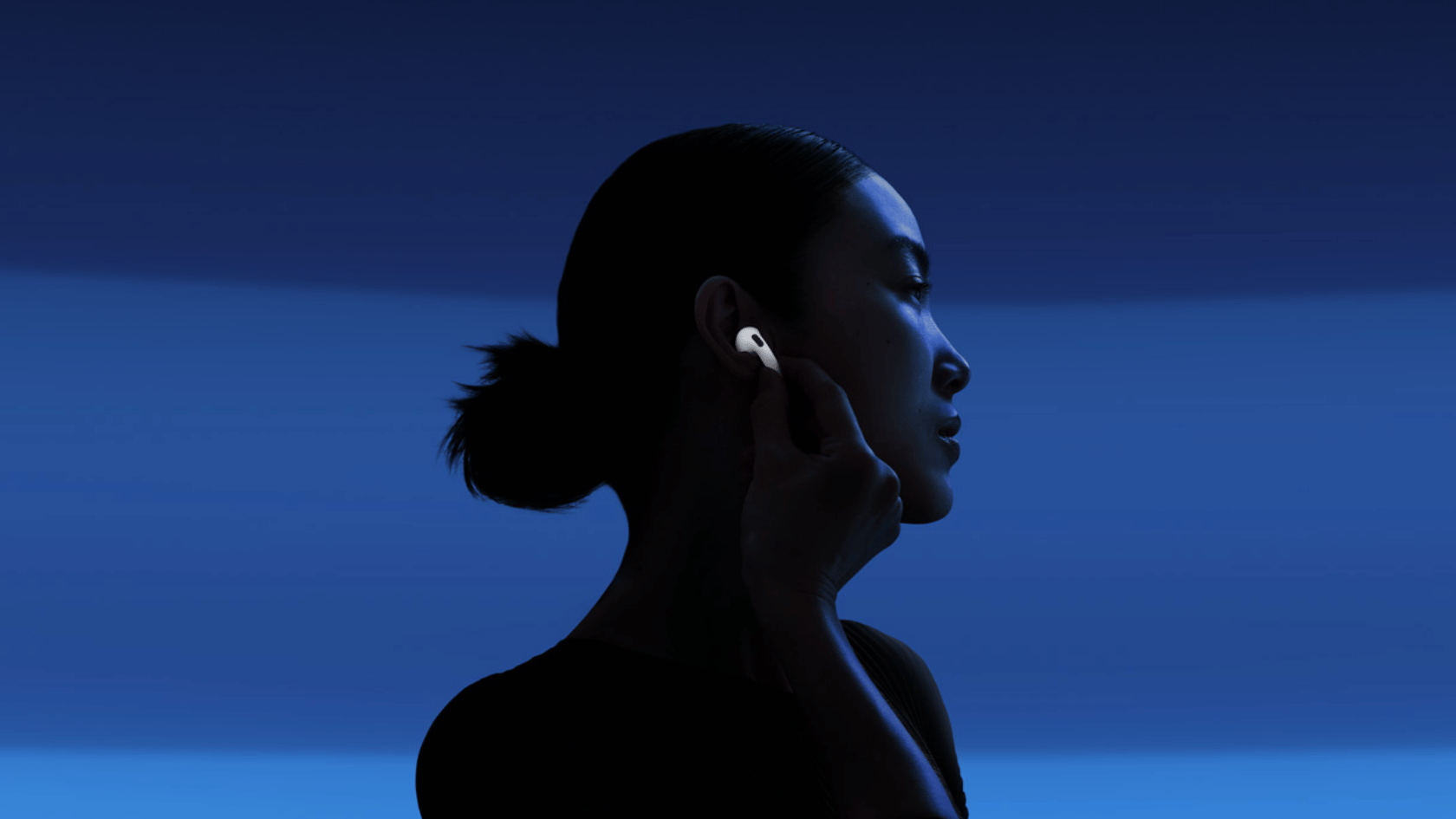 Person wearing a single AirPod in their ear, adjusting it, with a blue gradient background.