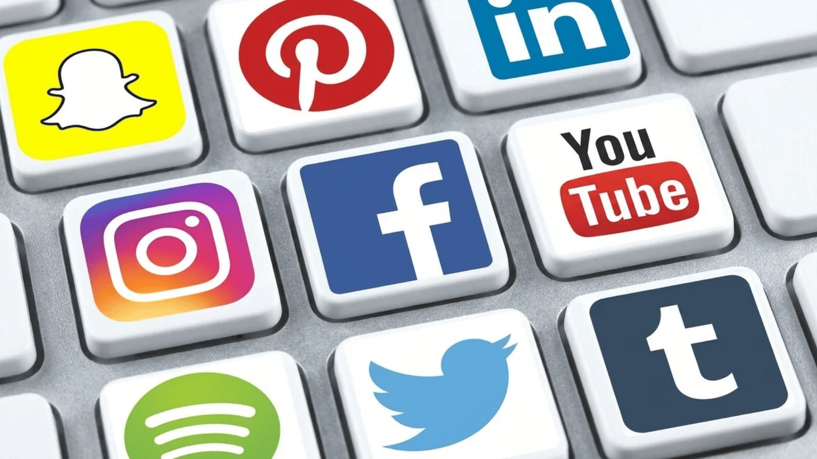 Keyboard keys featuring social media app logos including Snapchat, Pinterest, LinkedIn, Instagram, Facebook, YouTube, Twitter, and Spotify.