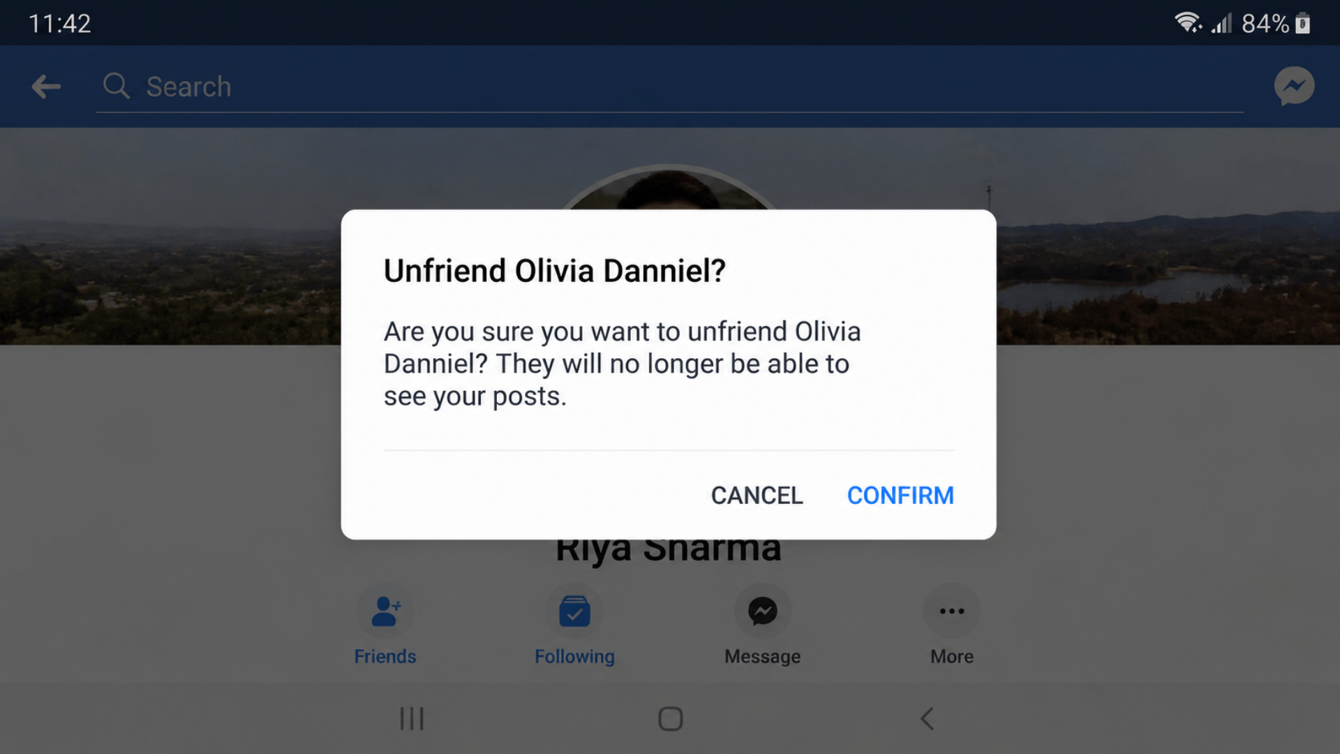 Unfriend Olivia Danniel? confirmation dialog with text and Cancel and Confirm buttons on Facebook mobile screen